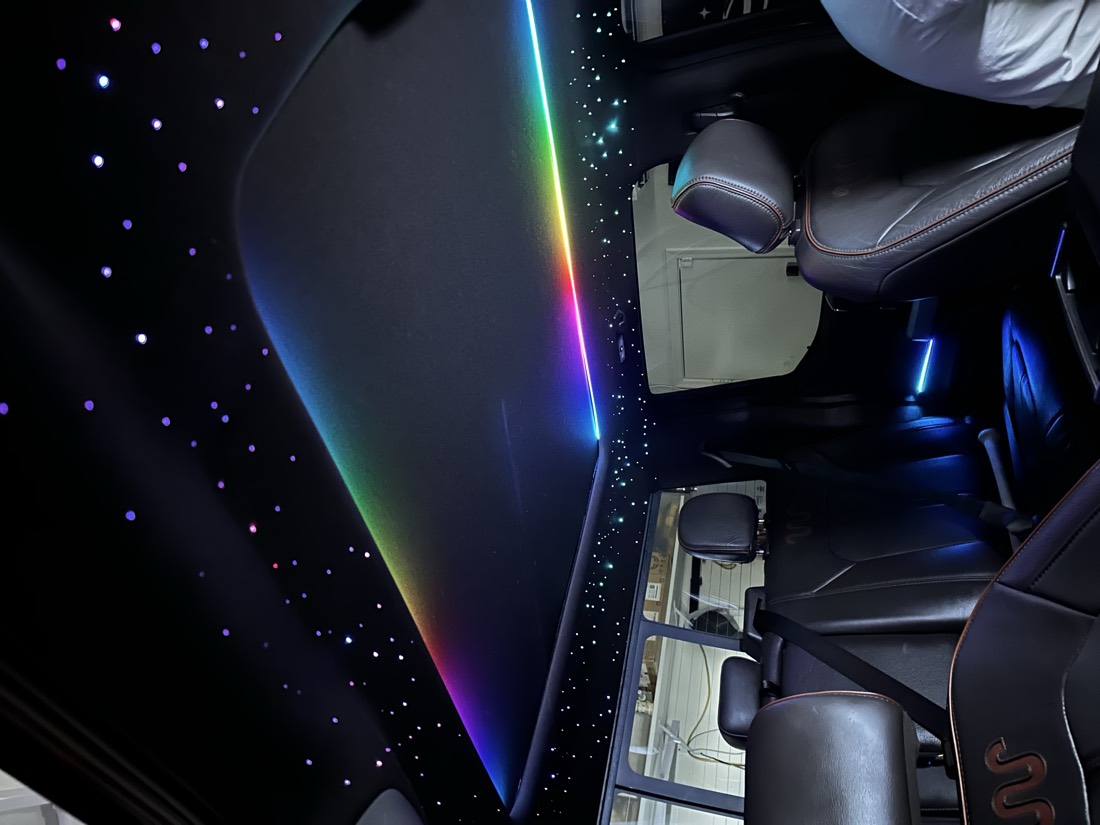 Ford F-150 King Ranch headliner filled with stars, with a rainbow ambient strip running the length of the panoramic roof